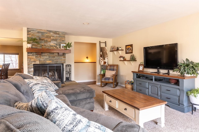 carpeted living room featuring a stone fireplace