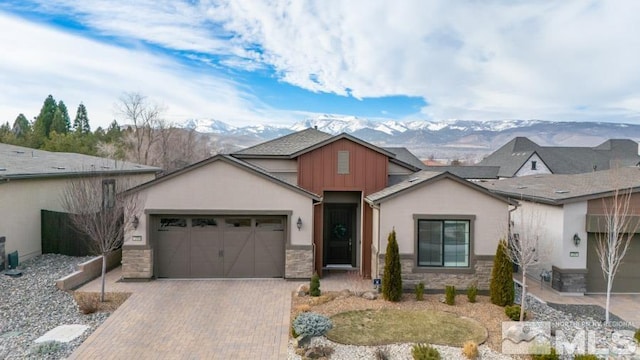 view of front facade with a garage and a mountain view