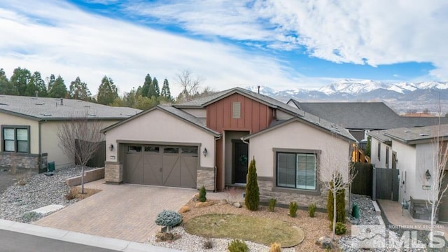 view of front of property with a mountain view and a garage