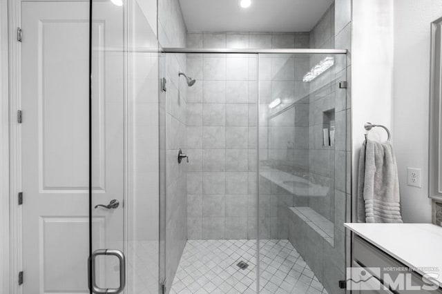 bathroom featuring vanity and an enclosed shower