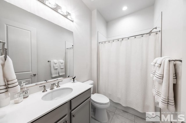 full bathroom featuring shower / tub combo, vanity, toilet, and tile patterned flooring