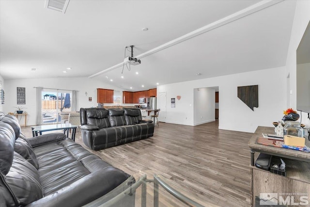 living room featuring hardwood / wood-style flooring and vaulted ceiling