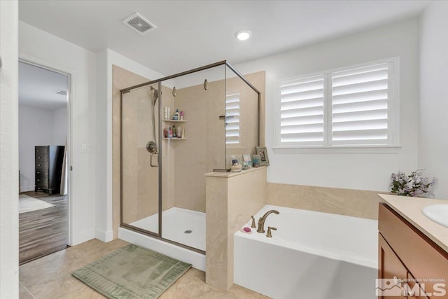 bathroom featuring vanity and separate shower and tub