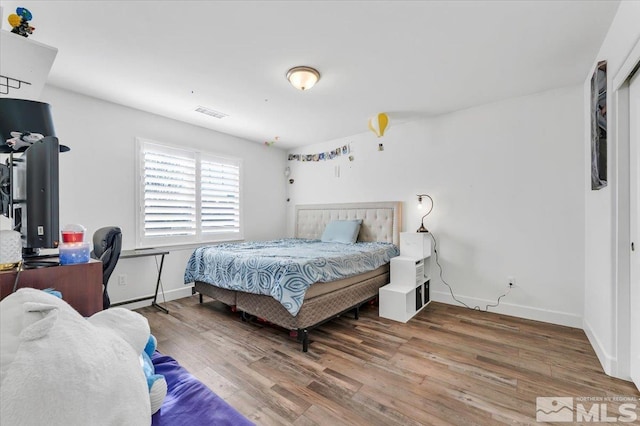 bedroom with wood-type flooring