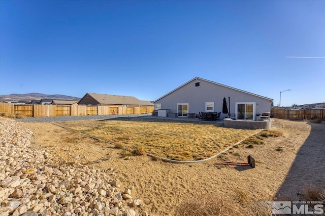 back of property with a mountain view