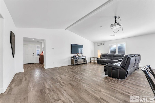 living room featuring lofted ceiling and hardwood / wood-style floors