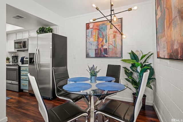 dining space featuring dark wood-type flooring and a chandelier