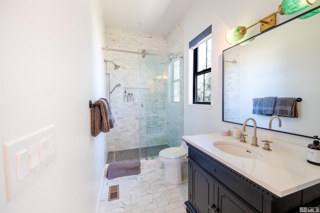 bathroom featuring vanity, toilet, a shower with shower door, and tile patterned flooring