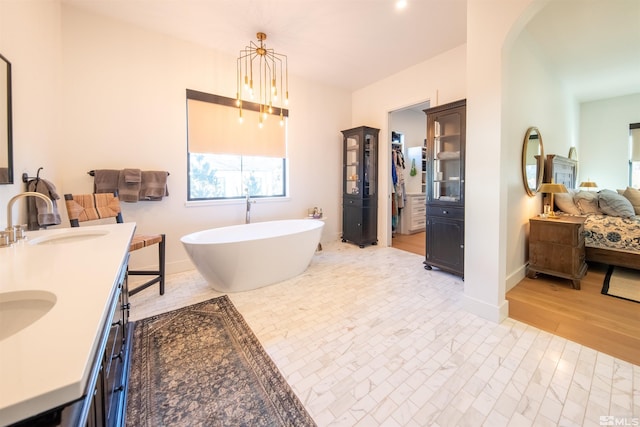 bathroom featuring vanity, wood-type flooring, and a bathing tub