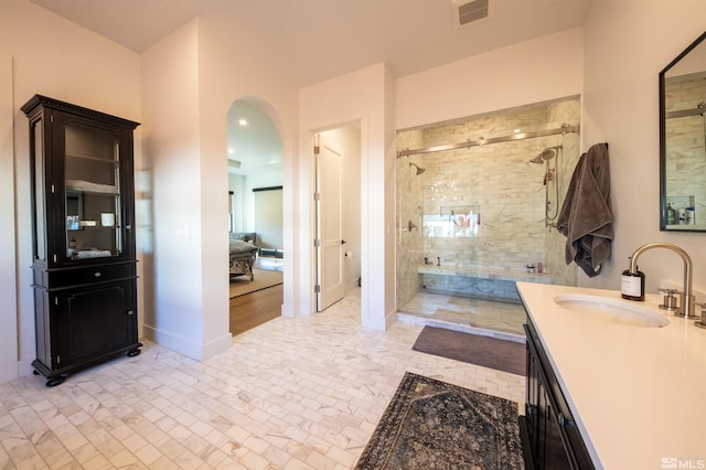 bathroom featuring vanity and a shower with door