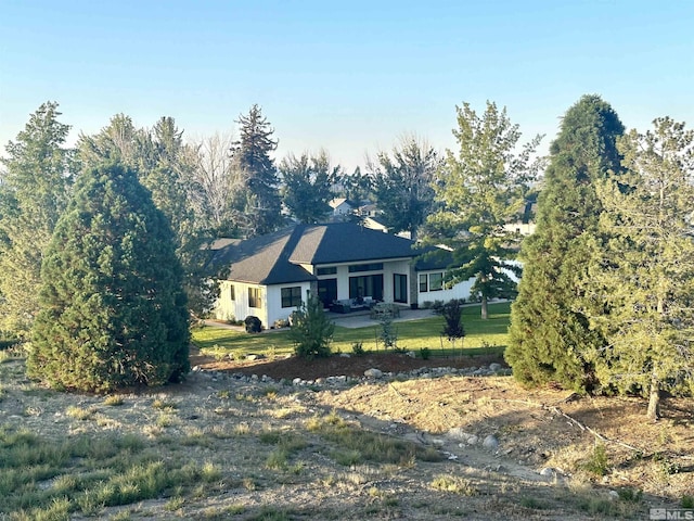 view of front of home with a patio area and a front yard