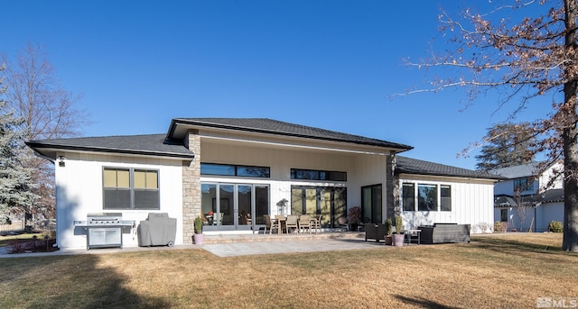 rear view of house featuring a patio and a lawn