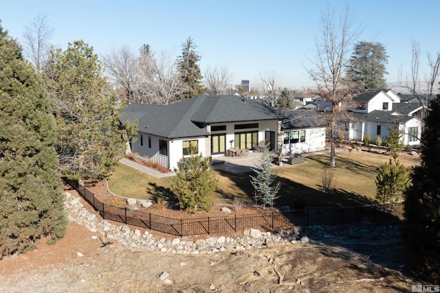 rear view of property with a patio area and a lawn