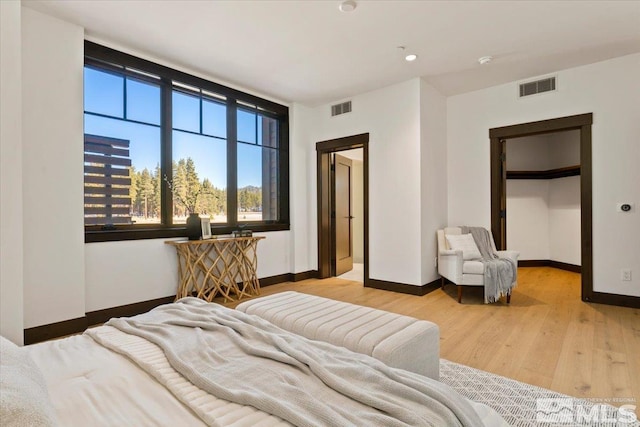 bedroom featuring a closet and light hardwood / wood-style flooring