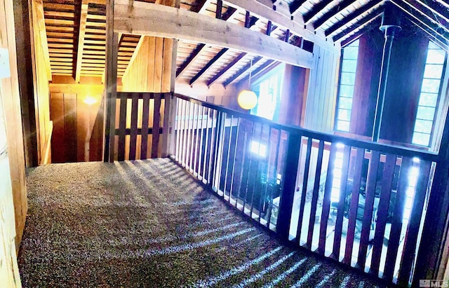 hall featuring wood ceiling, lofted ceiling with beams, and carpet flooring