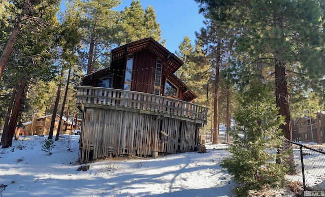 view of snow covered rear of property