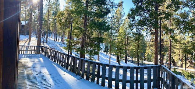 view of snow covered back of property