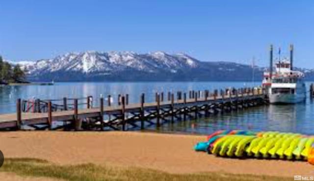 view of dock featuring a water and mountain view