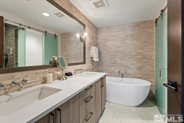 bathroom featuring vanity, a tub, and tile patterned floors