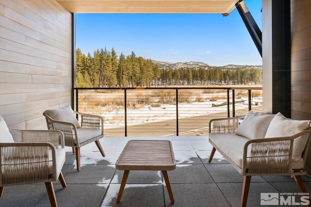 balcony featuring an outdoor living space and a mountain view