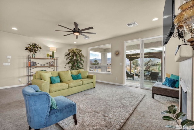 living room with ceiling fan and carpet flooring