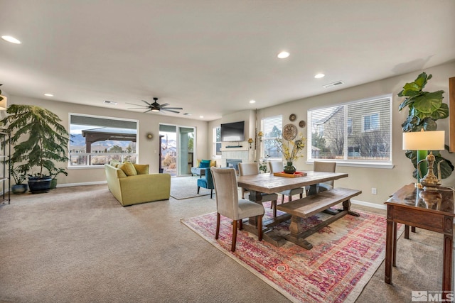 dining area featuring ceiling fan and carpet