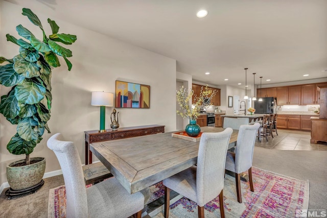 dining space with light tile patterned flooring and sink