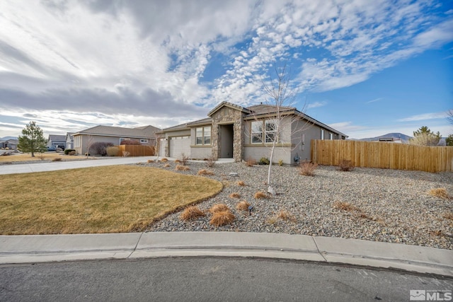 ranch-style home with a garage and a front yard