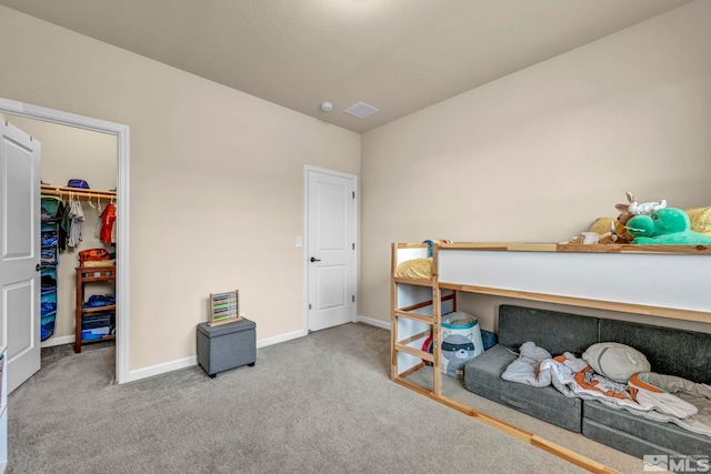 bedroom with carpet, a spacious closet, and a closet