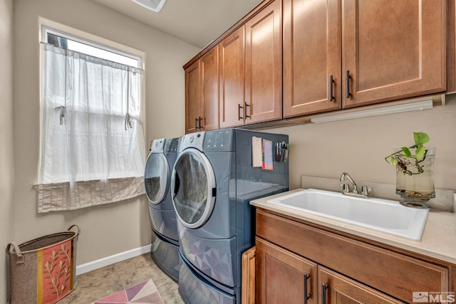 laundry area with sink, cabinets, and washing machine and clothes dryer