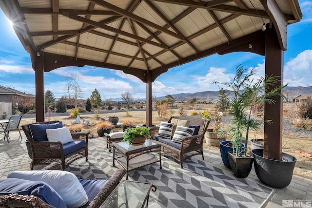 view of patio / terrace featuring a gazebo, outdoor lounge area, and a mountain view