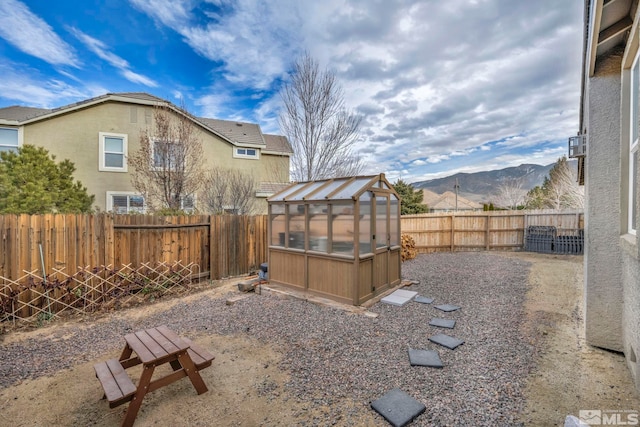 view of yard with a mountain view and an outdoor structure