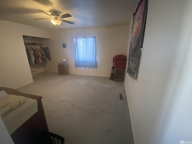 bedroom with a closet, ceiling fan, and carpet flooring