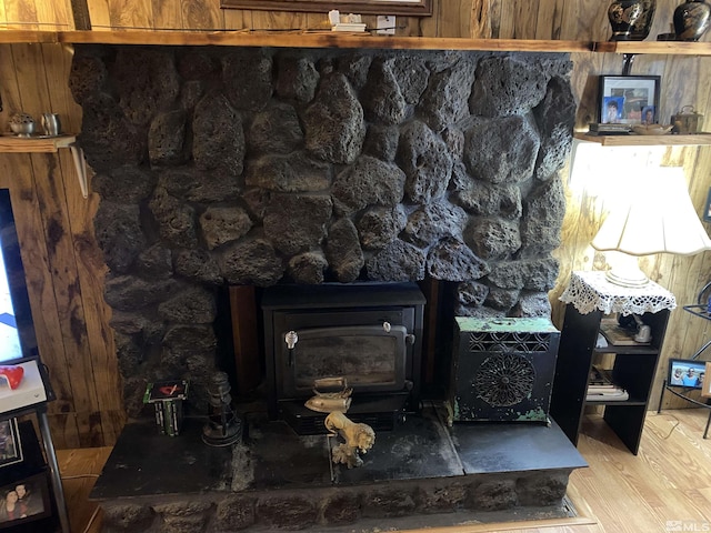 room details with hardwood / wood-style floors and a wood stove