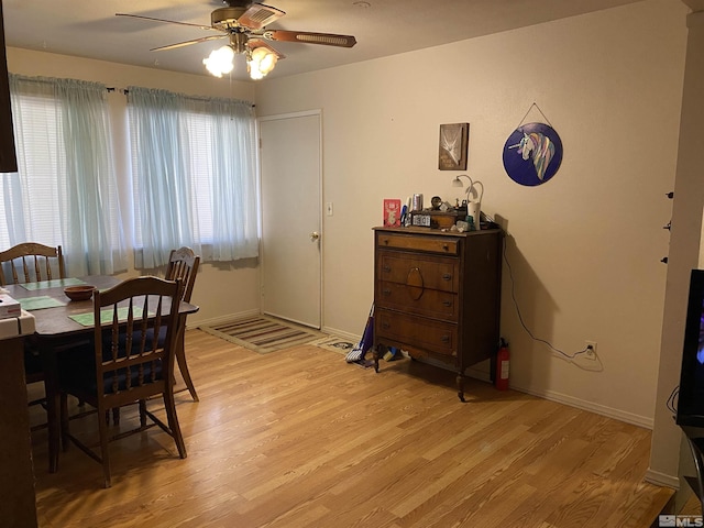 dining area with light hardwood / wood-style flooring and ceiling fan