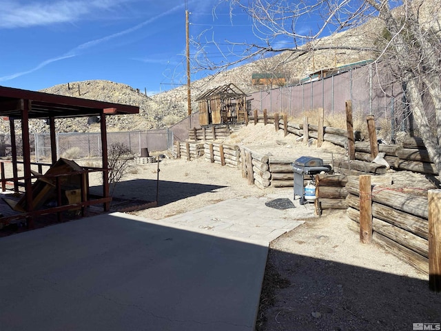 view of patio / terrace with a mountain view and a grill