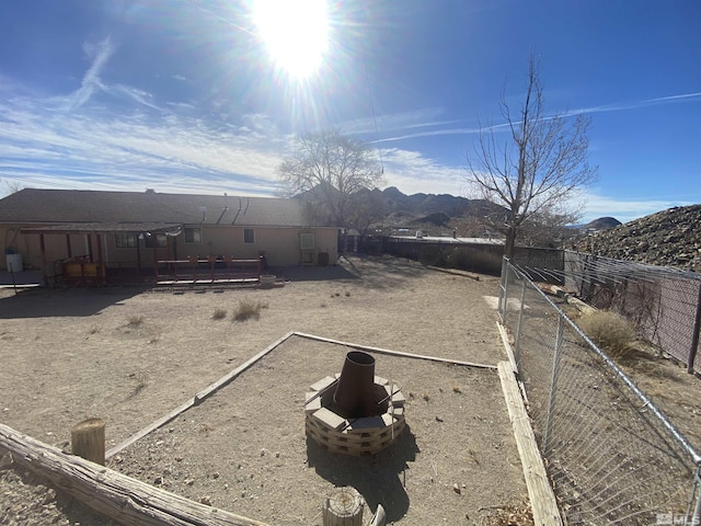 view of yard with a mountain view and an outdoor fire pit