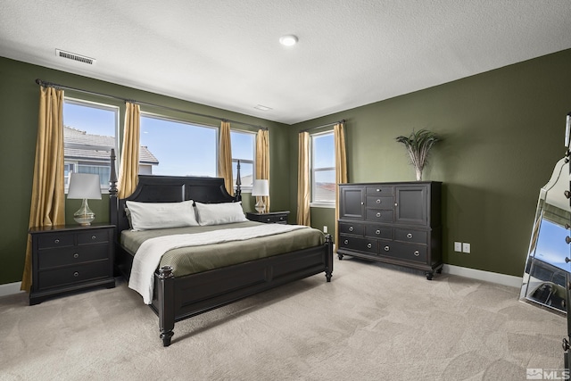 carpeted bedroom featuring a textured ceiling