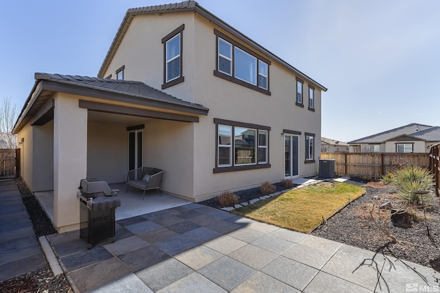 rear view of property with central AC and a patio area