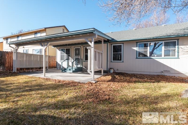 rear view of house featuring a yard and a patio