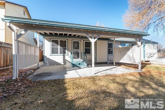 rear view of property with a lawn