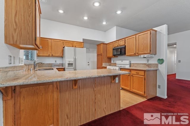 kitchen with sink, light carpet, kitchen peninsula, white appliances, and light stone countertops