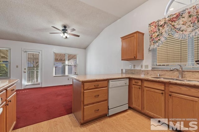 kitchen featuring lofted ceiling, sink, a textured ceiling, white dishwasher, and kitchen peninsula