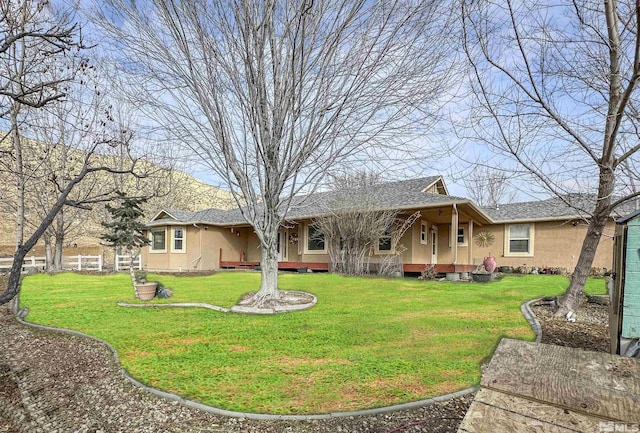 rear view of property with a yard