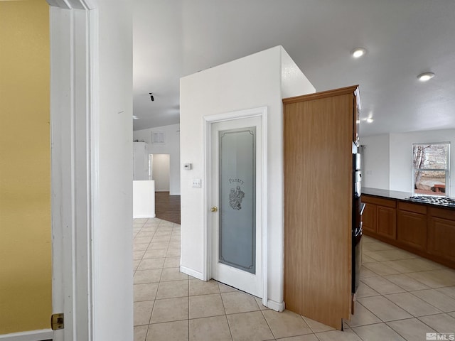 kitchen featuring stainless steel gas stovetop and light tile patterned floors