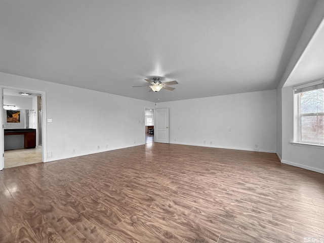 unfurnished living room with ceiling fan and light hardwood / wood-style floors