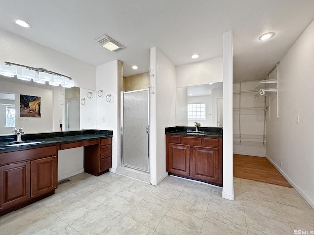 bathroom with vanity and an enclosed shower