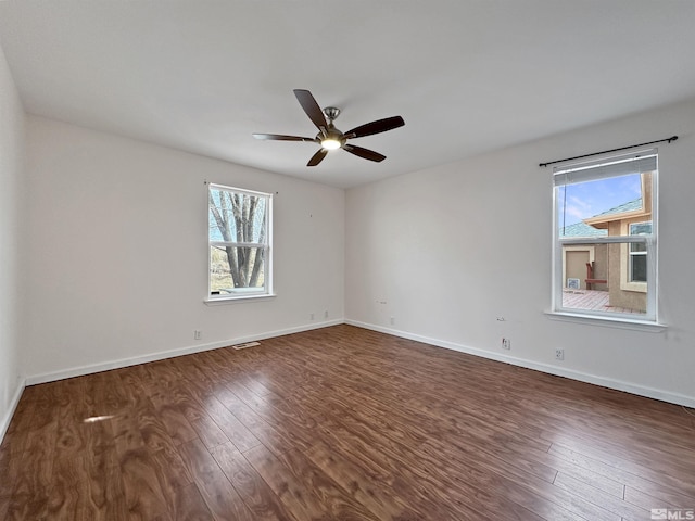 spare room with ceiling fan and dark hardwood / wood-style flooring