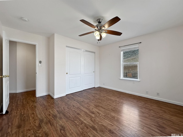 unfurnished bedroom featuring dark hardwood / wood-style flooring, a closet, and ceiling fan