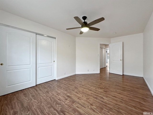 unfurnished bedroom with ceiling fan, dark hardwood / wood-style flooring, and a closet